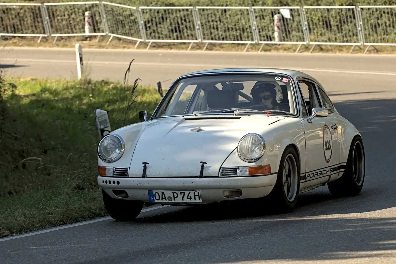 Classic Porsche 911 driving on a winding road